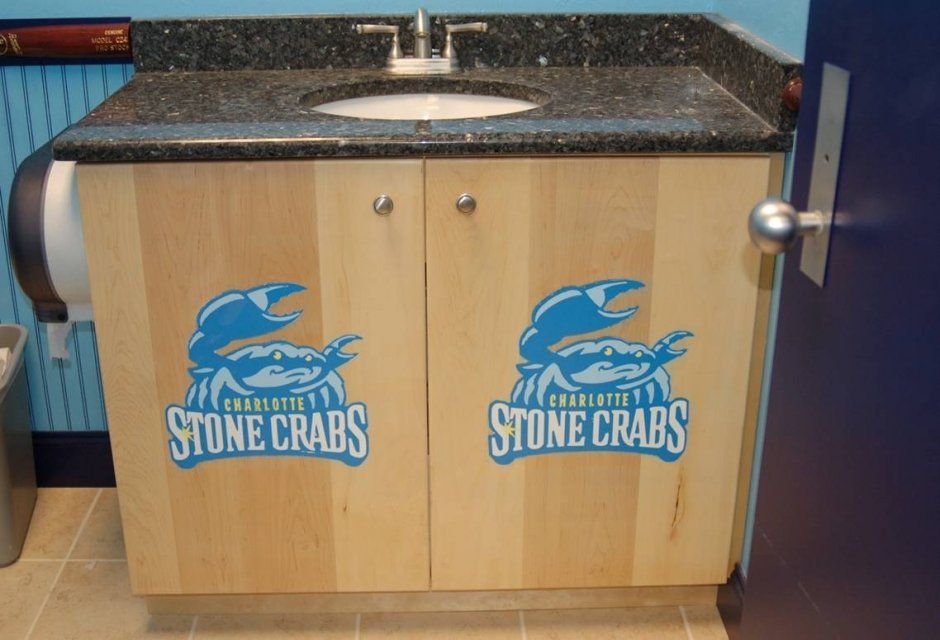 We miss our Stone Crabs! Commercial bathroom remodel with brand logo on slab doors.
