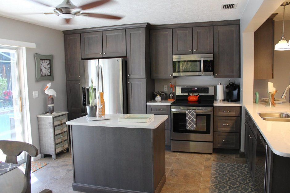 Stained wood shaker cabinetry kitchen remodel with satin nickel knobs and pulls.