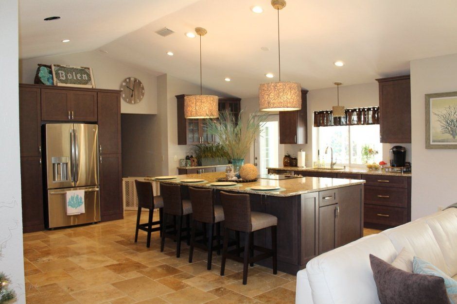 Maximum storage kitchen remodel with dark brown stained shaker cabinets and stainless steel appliances.