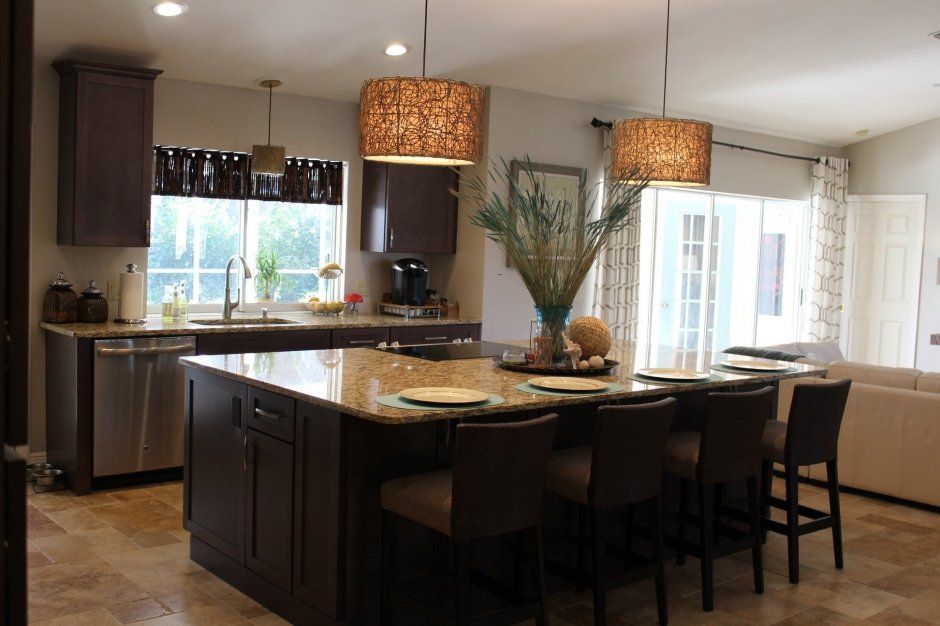 Dark stained wood shaker cabinetry with large statement island. Kitchen remodel.