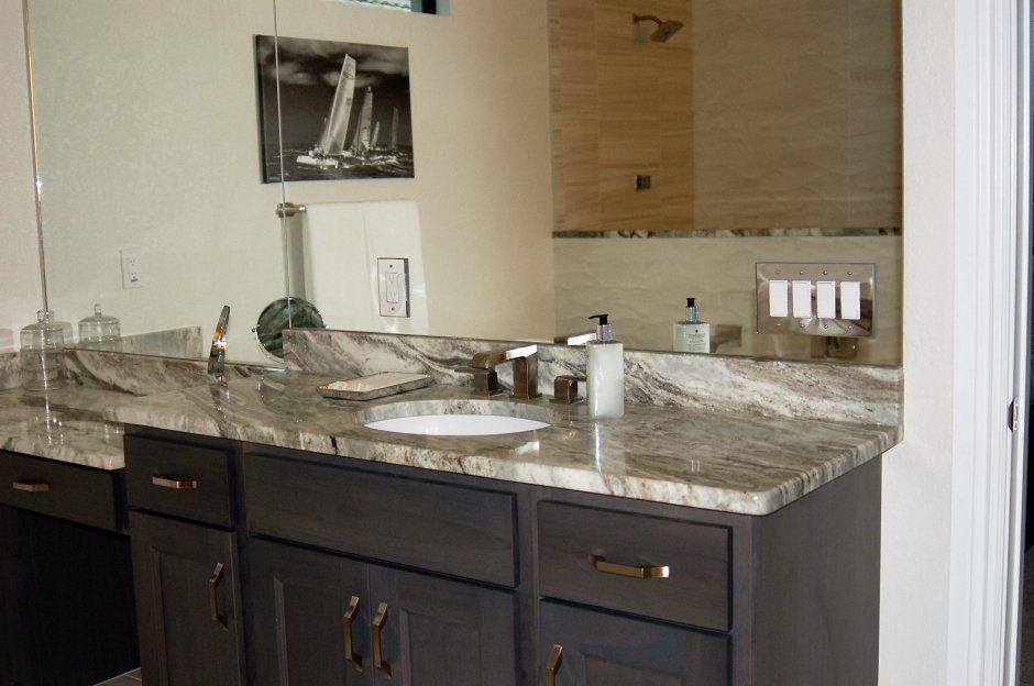 Master bathroom remodel with quartz countertops and makeup area. Large mirrors show the beauty of the full room.