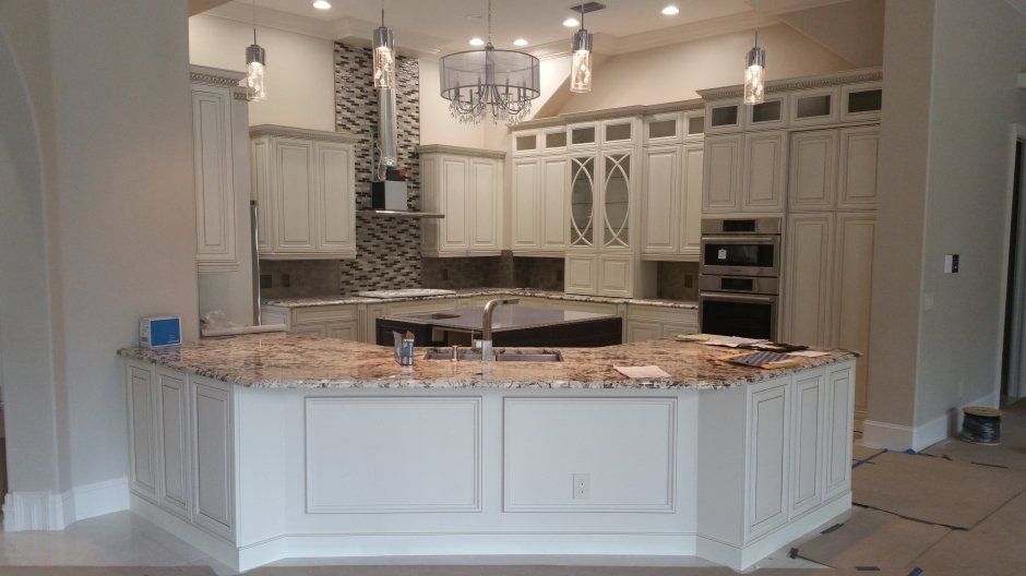 Unique angled peninsula cabinetry with wall wrapped in matching cabinet material.