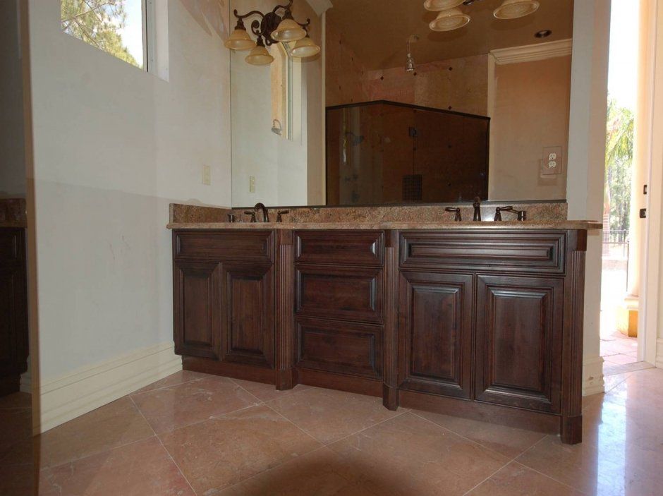 Dark stained multi-depth raised panel traditional style master bathroom remodel.