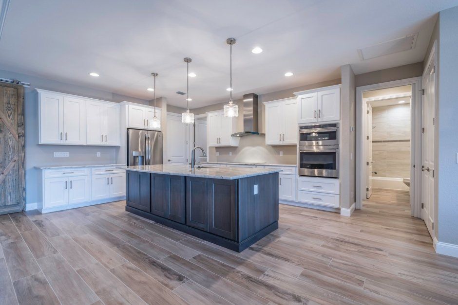 Large accent island with maximum storage and seating. Shaker cabinets with stainless appliances.