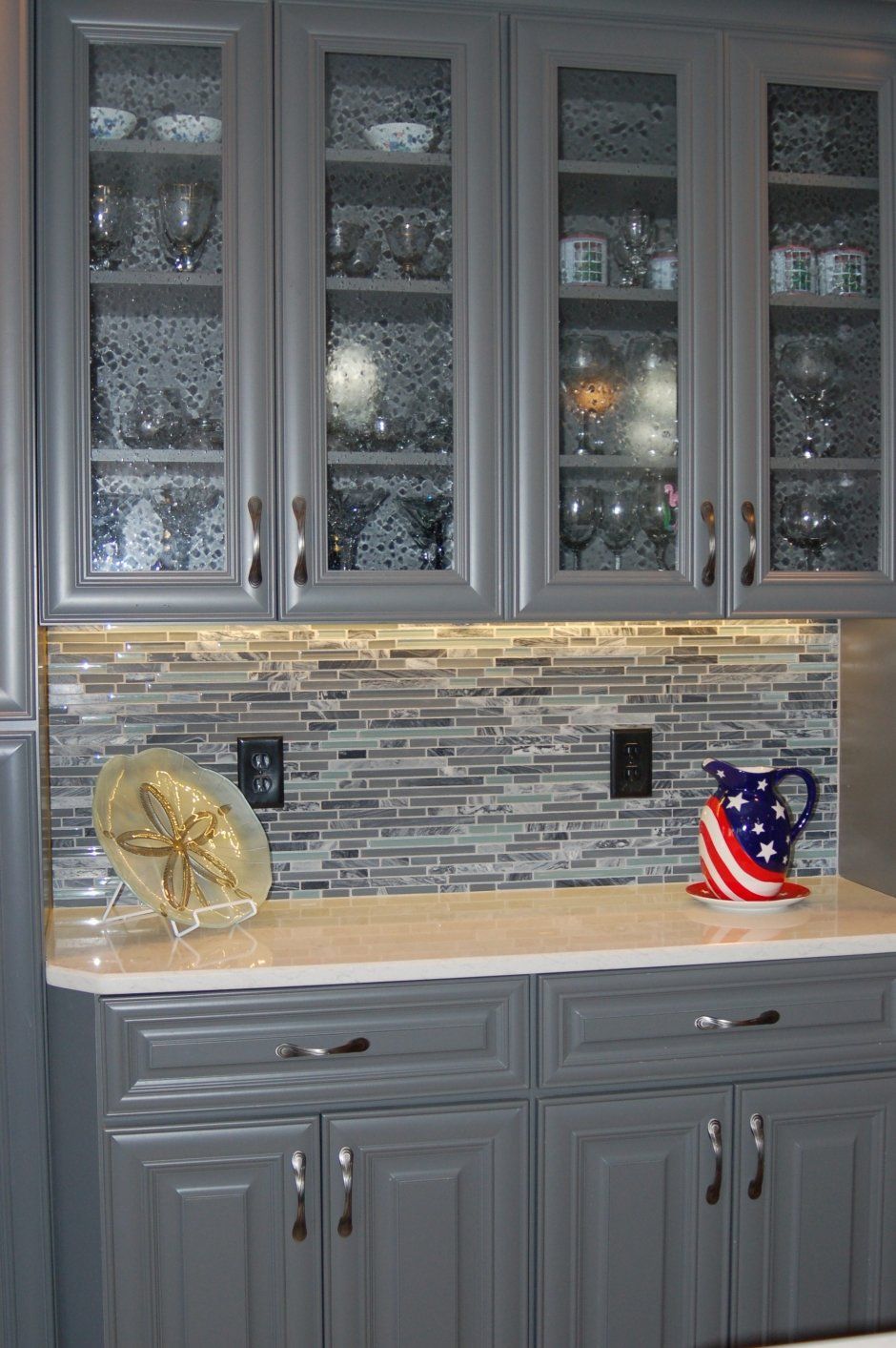 Glass door inserts on grey profiled classic doors. China cabinets.