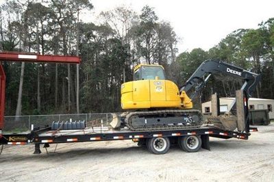 Mini Excavator On A Trailer Truck — Panama City, FL — Parker Septic Mini Excavator On A Trailer Truck — Panama City, FL — Parker Septic