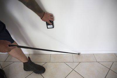 Man Spraying Pesticide In Kitchen — Savannah, GA — Johnson Exterminating Inc. Man Spraying Pesticide In Kitchen — Savannah, GA — Johnson Exterminating Inc.
