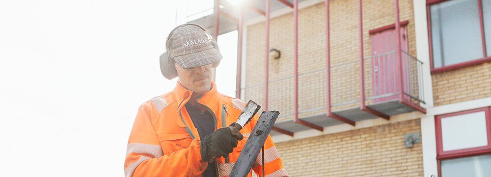construction worker with asphalt smoother