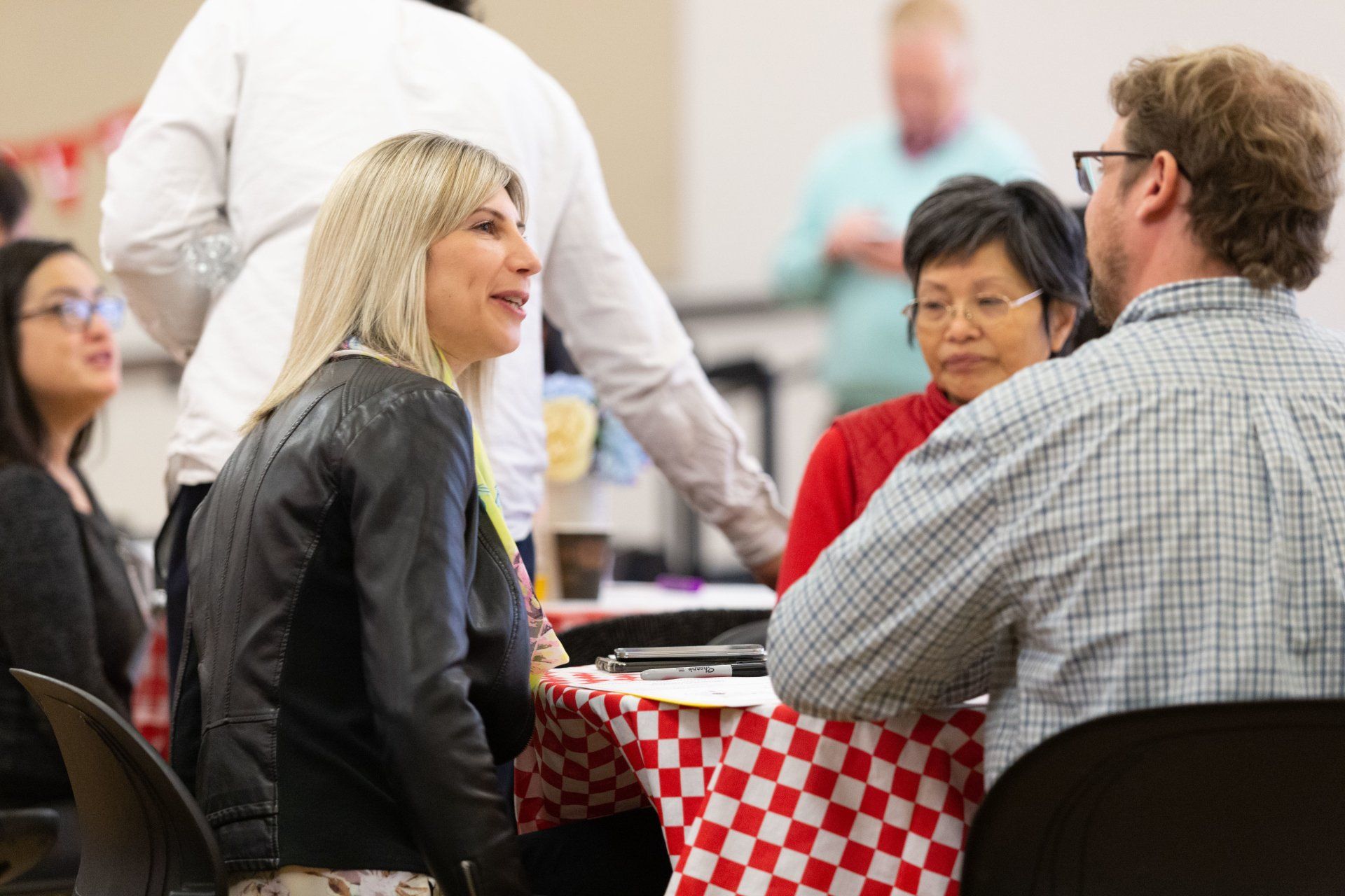 This is a picture that displays partners gathered around a table at a meeting.