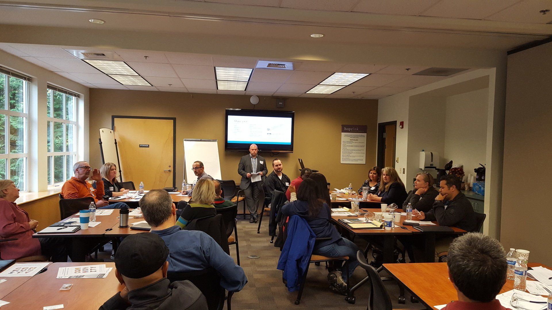 This picture displays a room with many members at a meeting.