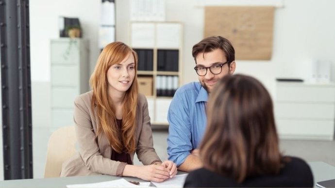 David Company helping you sell your dental practice I women facing two people selling your dental practice