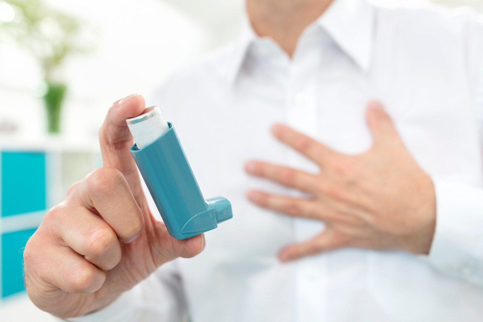 Man Using Asthma Inhaler — Hot Springs, AR — Jackson Allergy & Asthma Clinic
