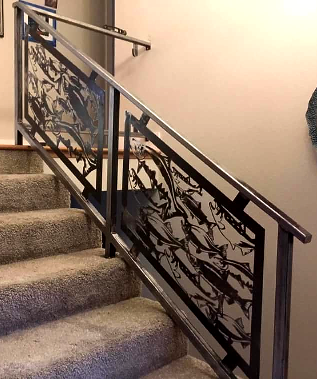 Carpeted stairway with decorative black metal railing and beige walls indoors