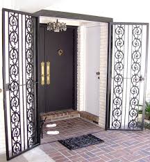 Open front entry with dark double doors, decorative wrought-iron screens, and brick patio steps.