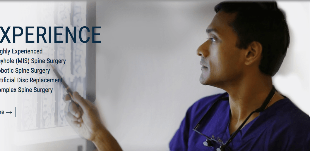 A man in a purple scrub is pointing at a white board that says experience