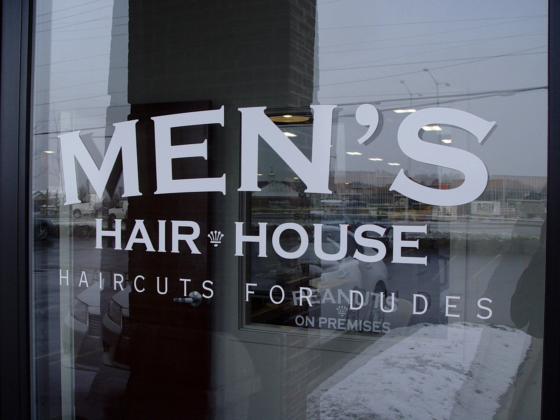 Men's Hair House shop window with white lettering: