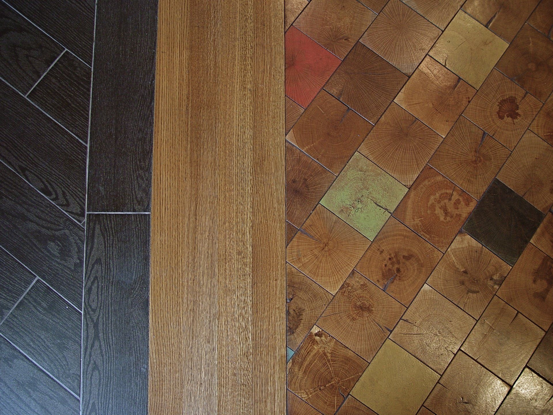 Three different flooring types: dark wood herringbone, light wood plank, and worn patterned tiles.