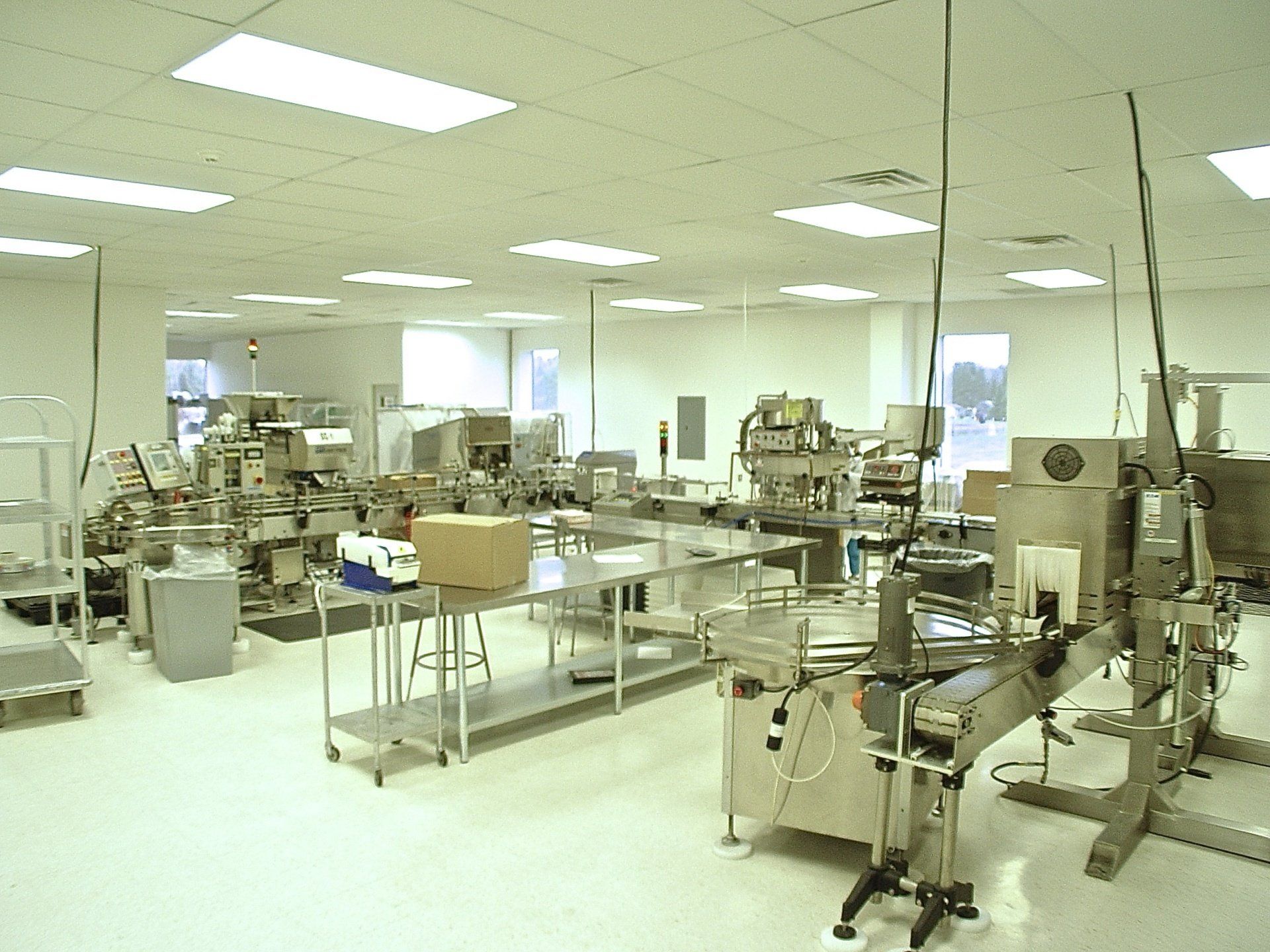A sterile factory interior with various machines and equipment, likely for food production, under bright lighting.