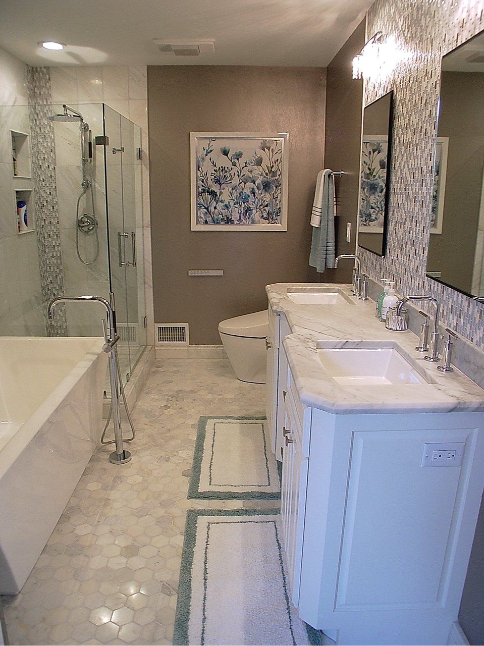 Elegant white bathroom with marble counters, double vanity, bathtub, shower, and floral artwork.