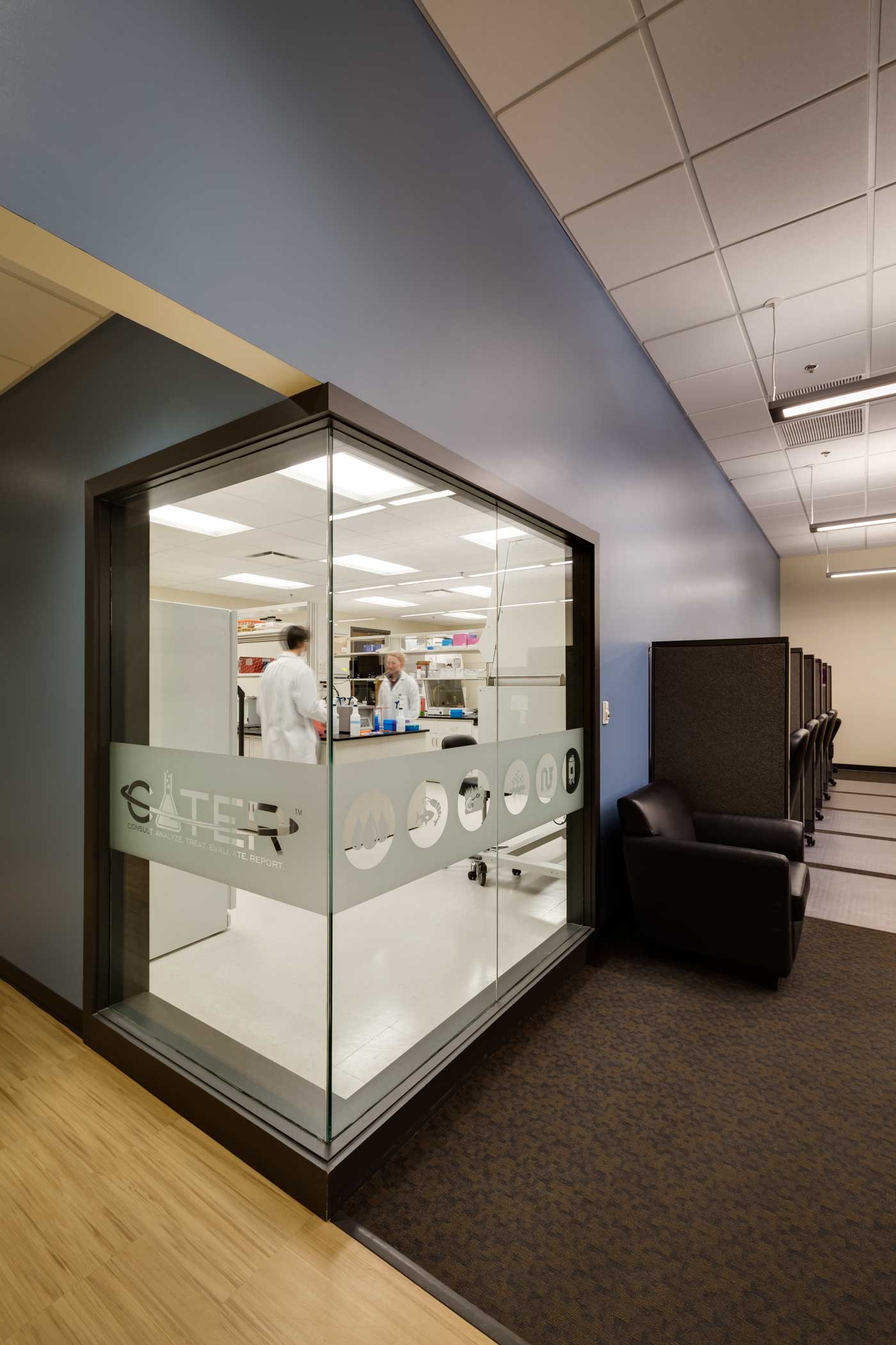Glass-walled room with people inside, frosted 