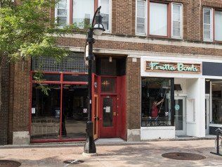 Exterior of brick storefronts: red door, 