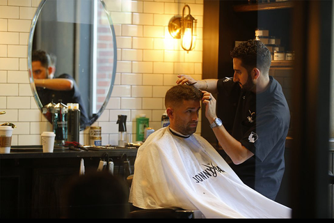 Jon cutting hair downtown