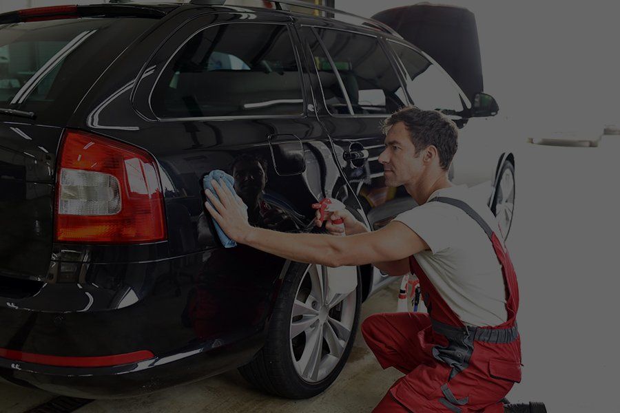 man wiping a car