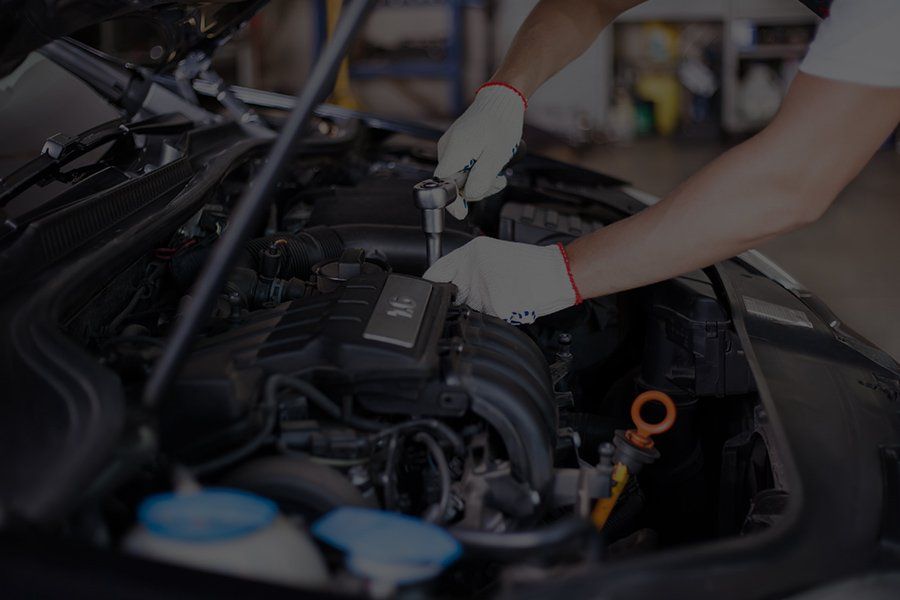 close up of someone working on a car engine