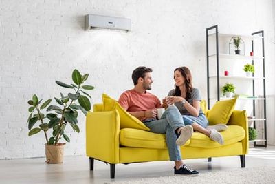 Air Conditioning Installation — Couple Talking in Living Room in Gaston, NC Air Conditioning Installation — Couple Talking in Living Room in Gaston, NC