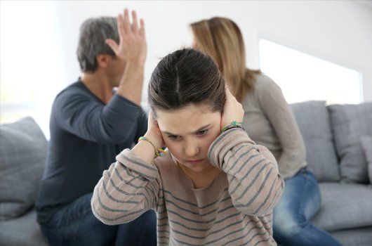 A child closing her ears