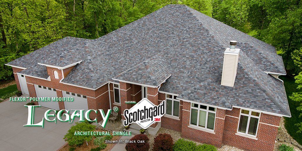 Brick house with gray roof and chimney, overlaid with the “Legacy School” logo and text