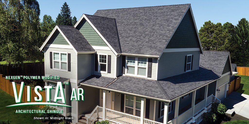 Aerial view of a gray house with a wraparound porch, labeled “VISTA AR Architects”