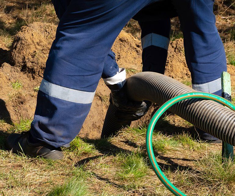Man Providing Sewer Cleaning Service — Chelan, WA — Jim’s Pumping Services, Inc. Man Providing Sewer Cleaning Service — Chelan, WA — Jim’s Pumping Services, Inc.