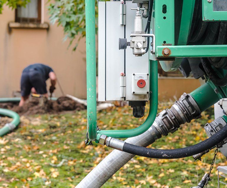 Worker Cleaning The Septic Tank — Chelan, WA — Jim’s Pumping Services, Inc. Worker Cleaning The Septic Tank — Chelan, WA — Jim’s Pumping Services, Inc.