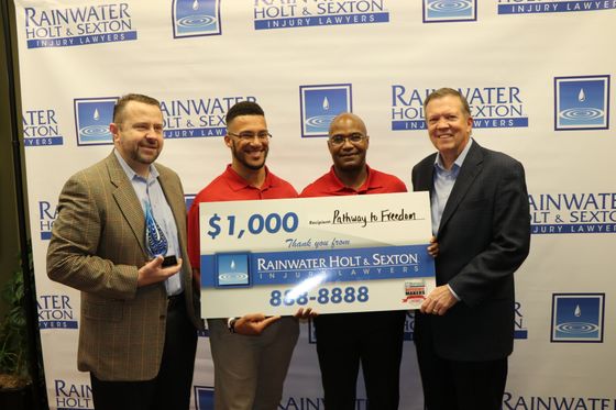 PTF members accepting donation from Rainwater, Holt, & Sexton