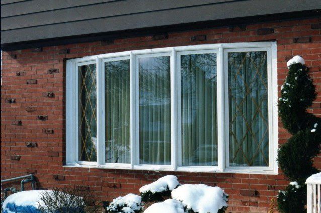 Rounded bay window with five single panels windows separated by white trim Grand Island, NY