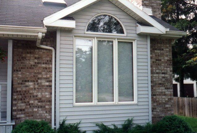 Three tall windows with rounded window above Tonawanda, NY