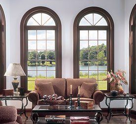 Matching rounded column windows with dark wood trim set in a white living room Grand Island, NY