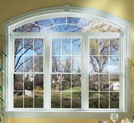 Large arched double hung window with white ornate trim