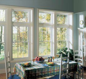 Double hung casement windows with white trim next to a dining area Buffalo, NY