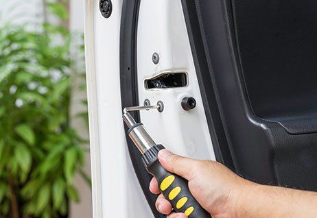 Man Repairing the Car Lock — Chicagoland, IL — AA Phil’s 24 Hour Lock & Key Man Repairing the Car Lock — Chicagoland, IL — AA Phil’s 24 Hour Lock & Key