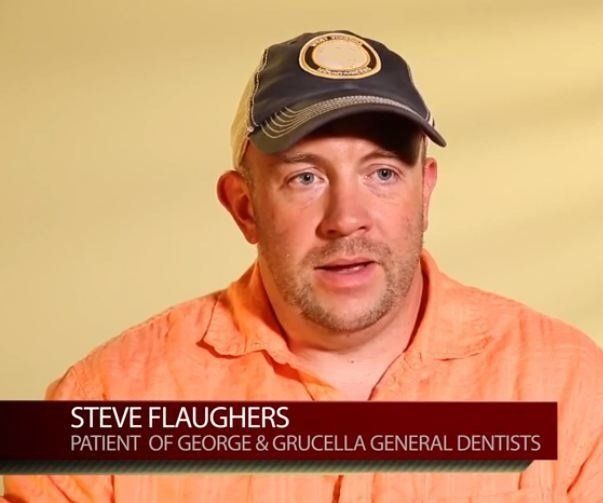 Man in black cap and orange shirt, identified as Steve Flaughers, on a testimonial interview backdrop.