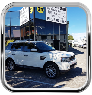white vehicle outside workshop