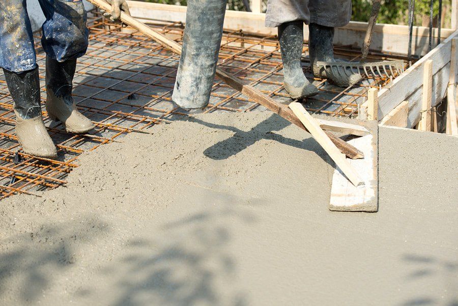 workers doing concrete work on building