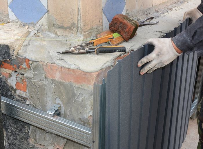 worker repairing wall in orange county, ca