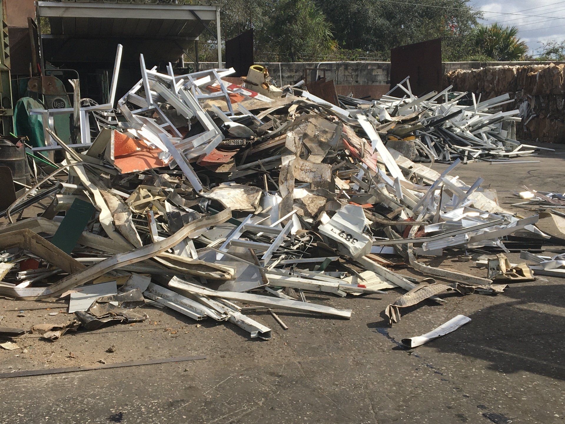 A pile of scrap metal is sitting on the side of the road.