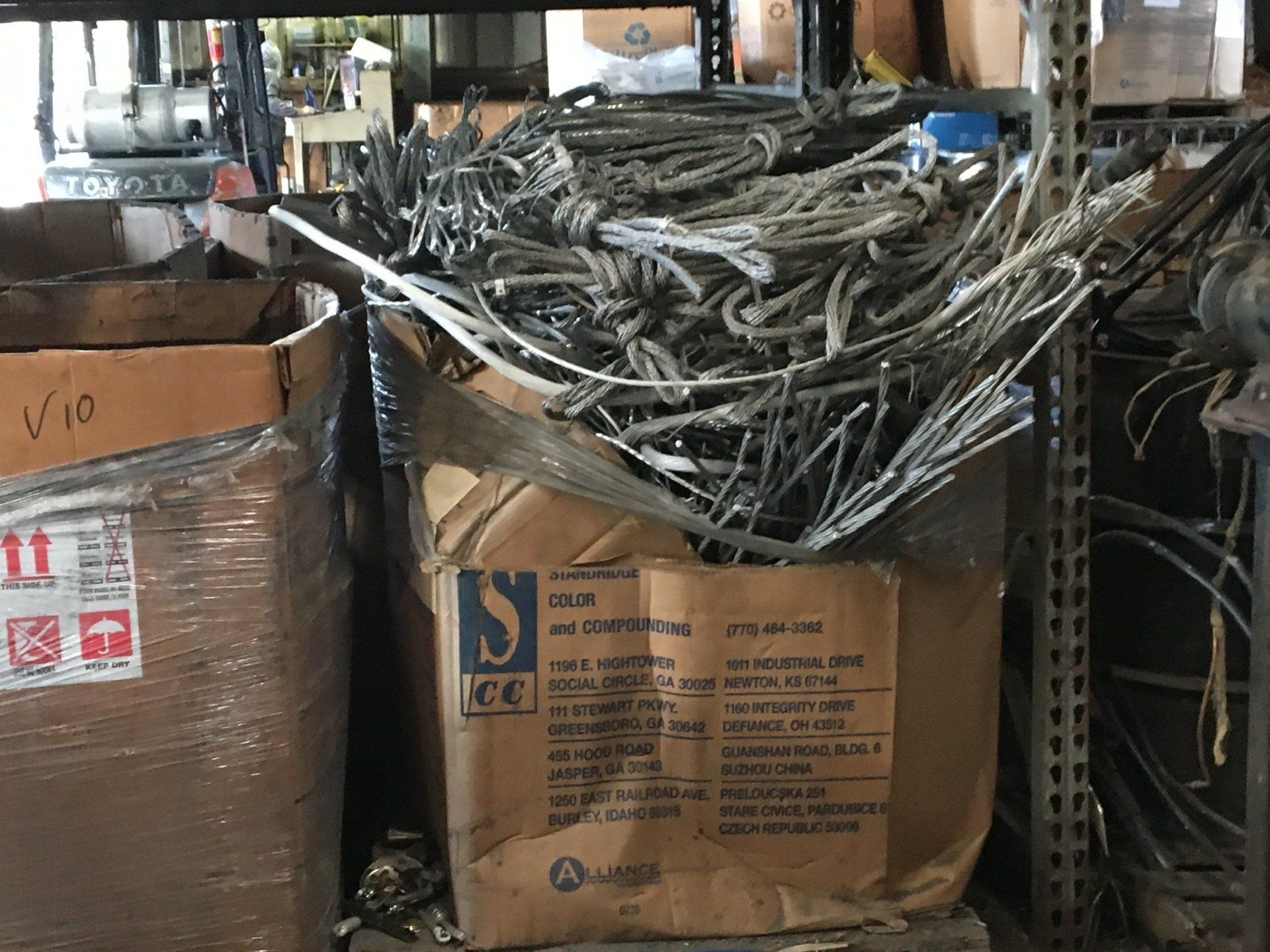 A box of wire is sitting on a shelf in a warehouse.