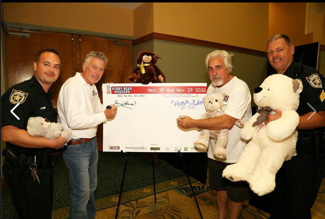 Buddy Bear® Weekend Founders Kevin and Hugo signing in with St lucie County Sheriff's Department on hand