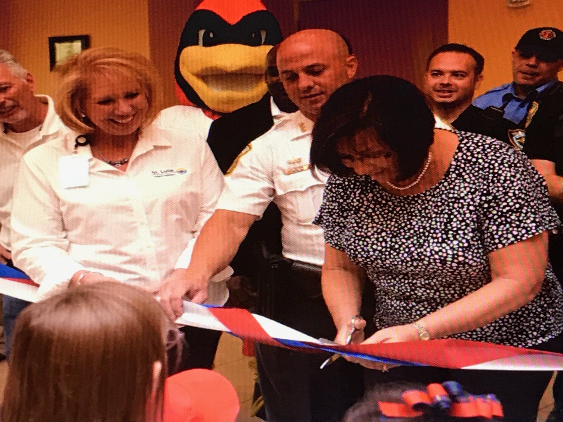 Cutting the ribbon to open up the. Iffy Bear den