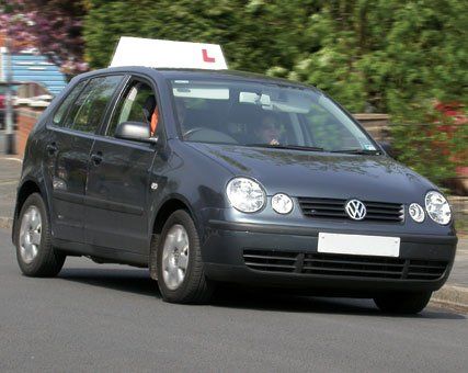 Grey car with learner sign on top of it